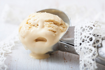 Homemade creamy ice cream in metal  scoop.