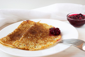 Pancakes with  jam on a white plate