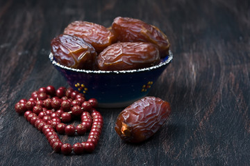 Dates fruit and rosary still life