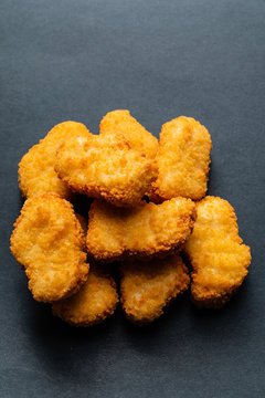 chicken nuggets on the black background