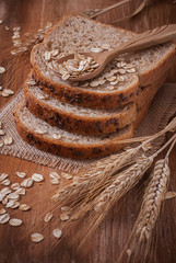 Plakat Healthy wholegrain bread on burlap napkin, located on wood back