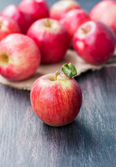 Red apple on a dark wooden background.
