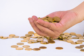 Many gold coin in hand on white background, business and financial investment concept.