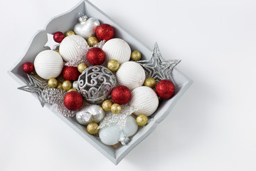 Christmas decorations in a wooden gray tray: balls, hearts, stars and free space for text