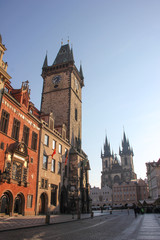 Obraz premium Early morning at Old Town Square. View of Two towers of Church of Our Lady before Tyn and The Old Town Hall with Orloj clock tower, center of the city in sunny day. Prague, Czech Republic