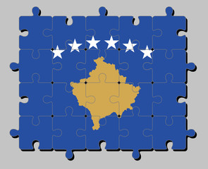 Fototapeta premium Jigsaw puzzle of Kosovo flag in a blue field charged with a map of Kosovo in gold, surmounted by an arc of six white star. Concept of Fulfillment or perfection.