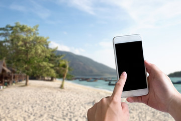 Mockup smartphone on sea beach view on background.