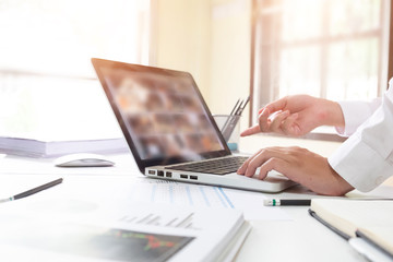Business man working with computer and finance data sheet paper, technology business.