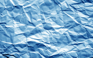 Crumpled sheet of paper in navy blue color.