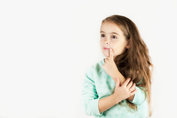 bright beautiful girl emotionally posing on an isolated turquoise background