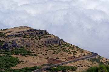 Empty mountain road against dense clouds on Pico do Arieiro on Madeira