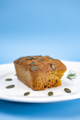Gluten-Free pumpkin bread with pumpkin seed in white plate.
