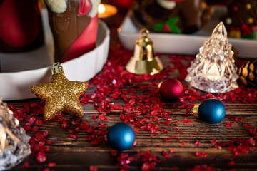 Christmas background with decorations on wooden table with warm lighting.