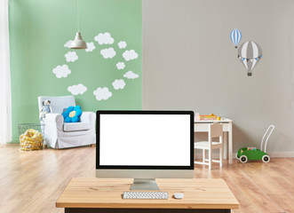 modern baby room blur background, close up desktop screen on the wooden desk.