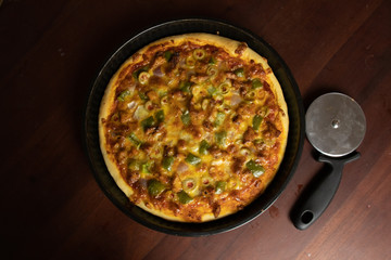 Pizza Pan take from top view with dark brown wood