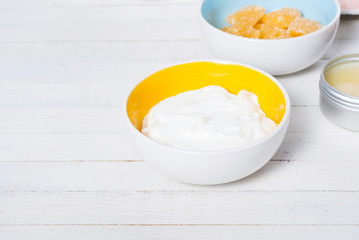 bath salts, beeswax , makeup base, powder compact, soaps and cosmetic creams on white wooden background