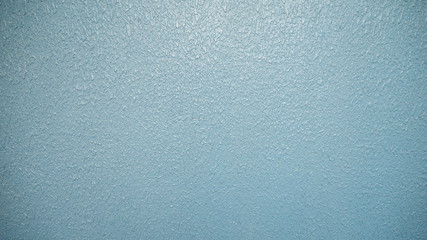 Light blue rough concrete wall texture background.