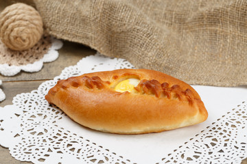 Baking with an egg in the center on the background of an openwork napkin