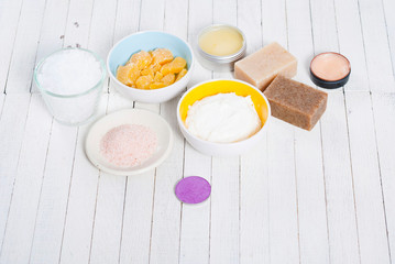 bath salts, beeswax , makeup base, powder compact, soaps and cosmetic creams on white wooden background
