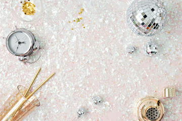silver ornaments in pink glitter background