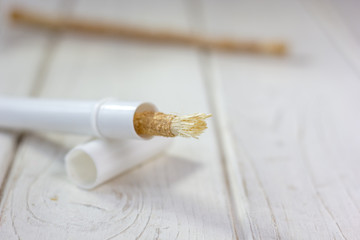 Miswak or siwak - arabian toothbrush for tooth cleaning on white.