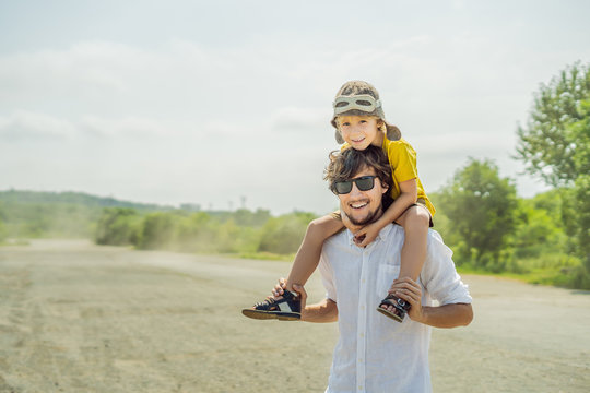 Happy father and son playing with toy airplane against old runway background. Traveling with kids concept - Powered by Adobe