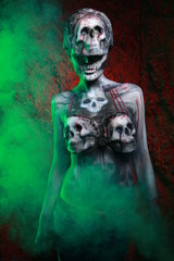 zombie death girl with scary body art posing in the night in thesmoke alone