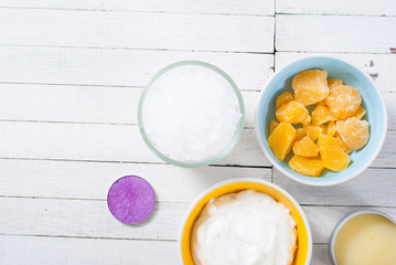 bath salts, beeswax , makeup base, powder compact, soaps and cosmetic creams on white wooden background