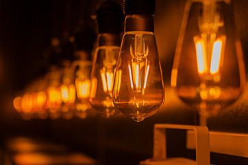 incandescent bulbs hang in a row
