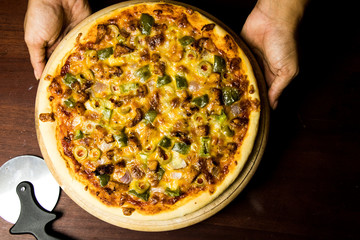 Pan Pizza take from top closeup hold hands and cutter