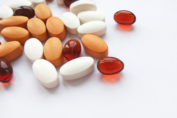 Assorted colorful pharmaceutical medicine pills, tablets and capsules on white background. Pharmacy theme, health care, drug prescription for treatment medication and pharmaceutical medicament