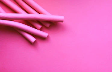 Pink foam curlers on soft pastel background. Hair accessories