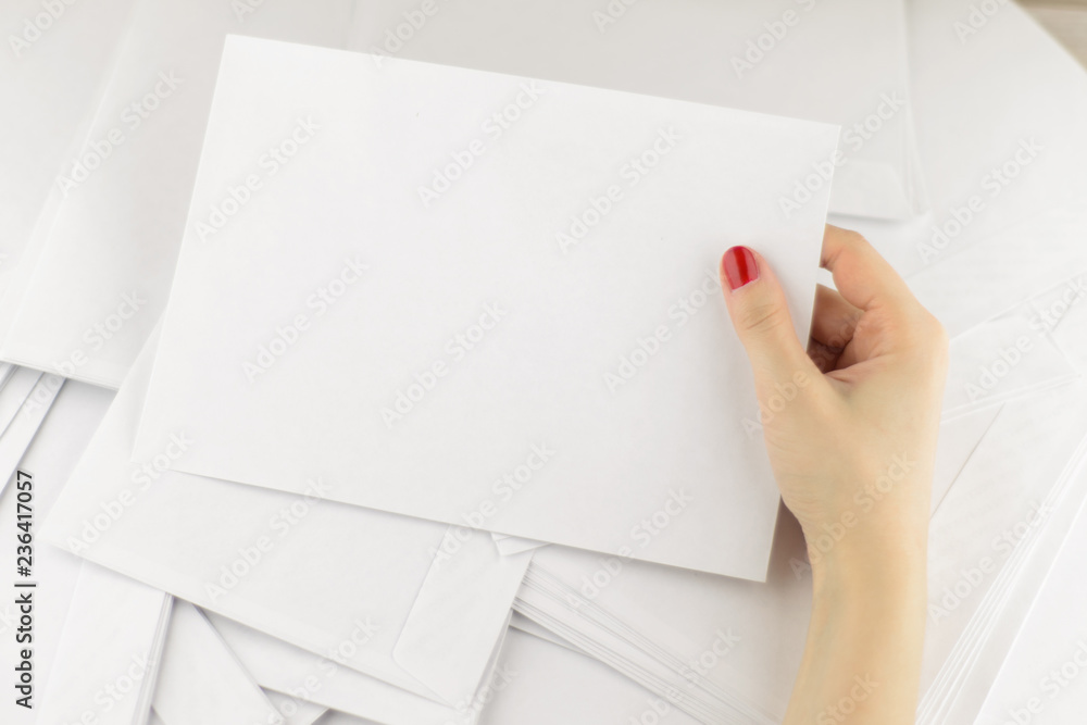 Wall mural work with correspondence: Girl picked up from the scattered pile of envelopes one of them at hand and ready to fill it