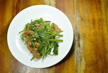 fried Chayote sprout with crispy chicken on plate