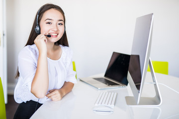 Young beautiful businesswoman with headset call center operator in office