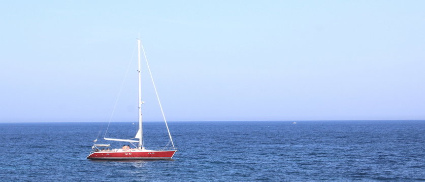 Beautiful sailing yacht in blue sea in fine clear weather