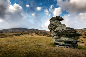 Sar Mountains - Sar Planina, Macedonia rock formation and grassy landscape under a    Cloudy Sky