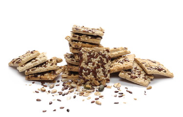 Salty integral flour crackers with linseed and sunflower seeds isolated on white background