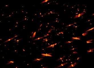 Fire sparks flying up. Glowing particles on a dark background textire for text or space