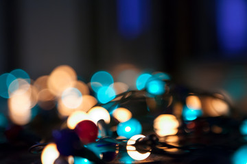 electric colored garland shine on black surface