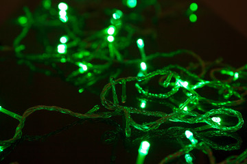 electric colored garland shine on black surface
