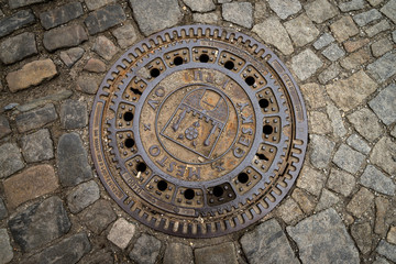 The metal plate drain hose on the stone road in Cesky Krumlov, Czech