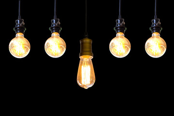 Vintage light bulb hanging over black background, Idea concept.