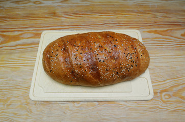 Freshly baked traditional Tatar bread with sesame (Miraba) placed on a white plate 