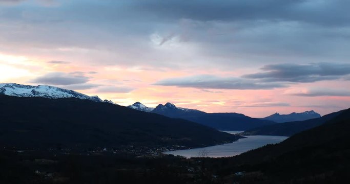 orange sunset with mountain summits, Norway, Gratangen