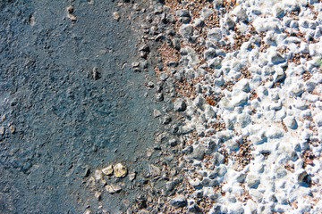 gray and white textured asphalt surface with small stones