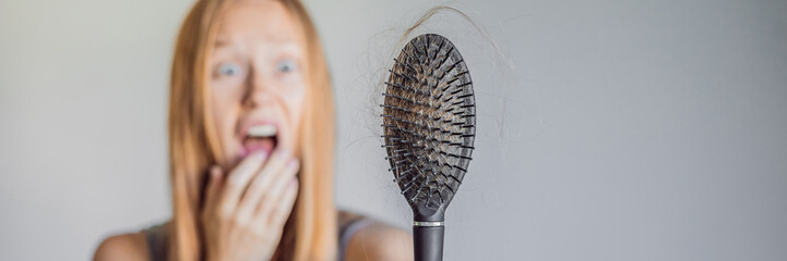 Hair loss in women concept. A lot of lost hair on the comb BANNER, LONG FORMAT