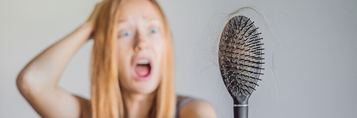 Hair loss in women concept. A lot of lost hair on the comb BANNER, LONG FORMAT