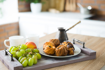 Breakfast on tray with fresh fruits and bakery.