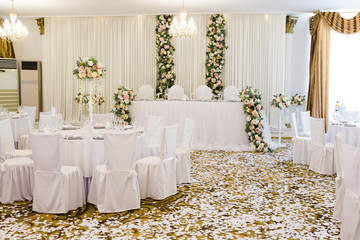 Wedding banquet in restaurant, tables with flowers